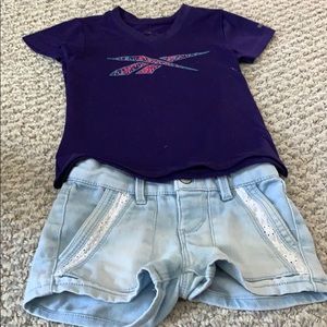 Reebok T-shirt w/ light blue jeans